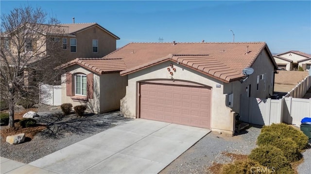 view of front of home featuring driveway, a tile roof, fence, and stucco siding