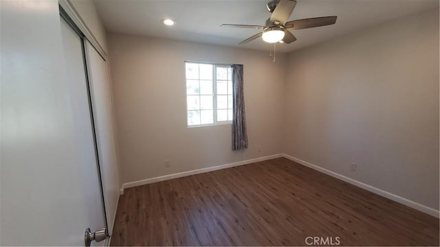 unfurnished bedroom with dark wood-style floors, recessed lighting, a closet, ceiling fan, and baseboards