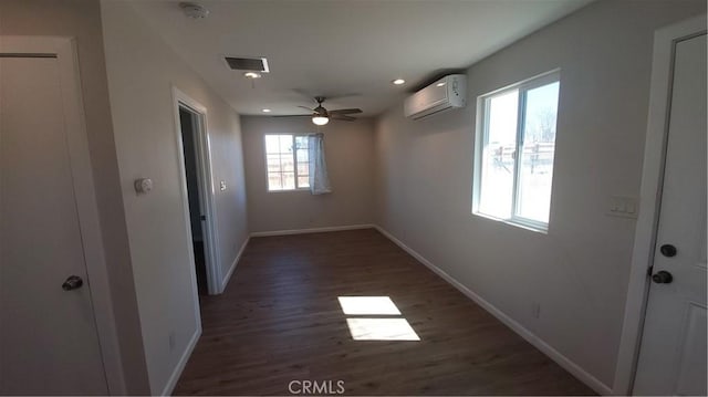 unfurnished room featuring baseboards, a ceiling fan, dark wood-style flooring, a wall mounted air conditioner, and recessed lighting