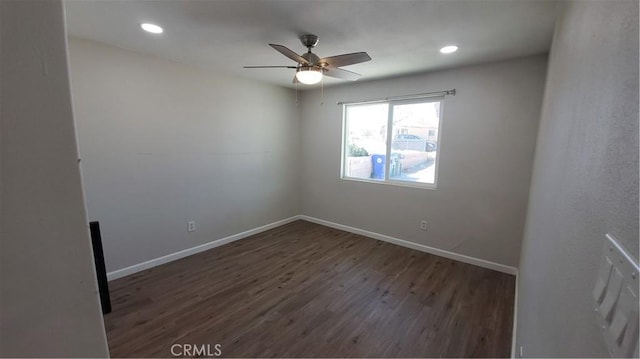 empty room featuring baseboards, dark wood finished floors, a ceiling fan, and recessed lighting