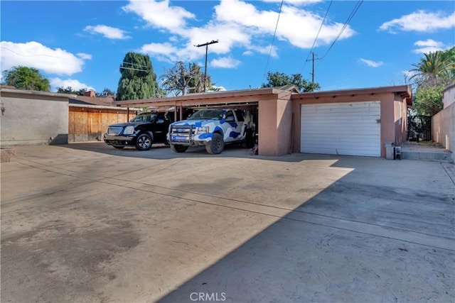 view of vehicle parking featuring fence