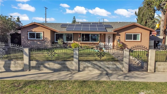 single story home featuring a fenced front yard, roof mounted solar panels, a front lawn, and stucco siding