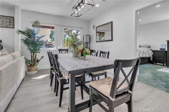 dining room featuring baseboards, light wood-style flooring, and recessed lighting