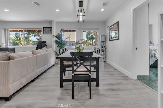 dining area with baseboards, light wood-type flooring, visible vents, and recessed lighting