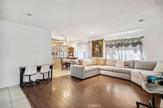 living room featuring hardwood / wood-style floors, a ceiling fan, and recessed lighting