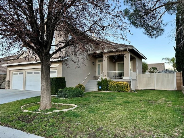 view of front of house with a front yard, concrete driveway, fence, and stucco siding