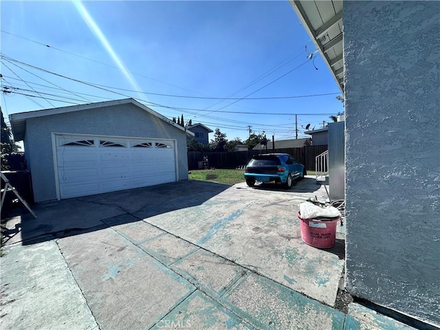 detached garage featuring fence