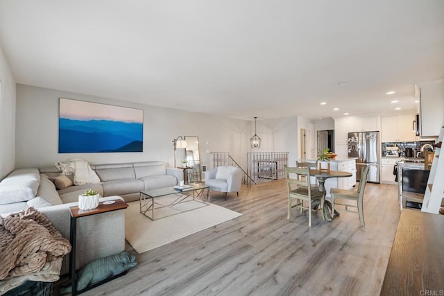 living room featuring light wood-type flooring and recessed lighting
