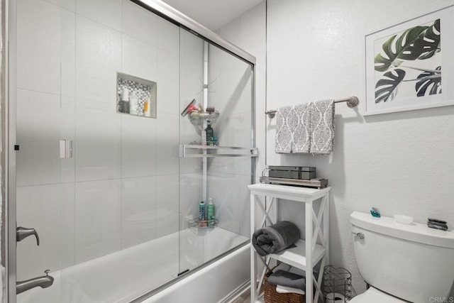 full bathroom with enclosed tub / shower combo and toilet