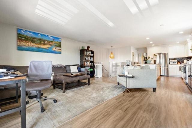 office space with light wood-style floors and recessed lighting