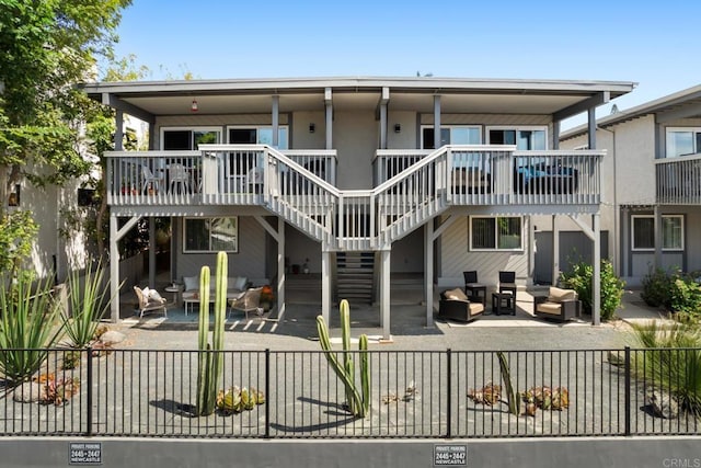 back of property with a patio area, stairway, outdoor lounge area, and fence private yard