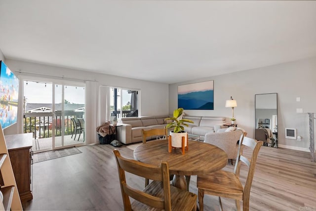 dining room featuring light wood-type flooring and baseboards