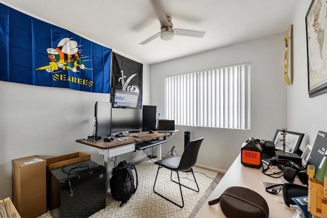 office with ceiling fan and baseboards