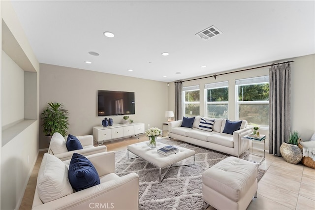 living room featuring recessed lighting and visible vents