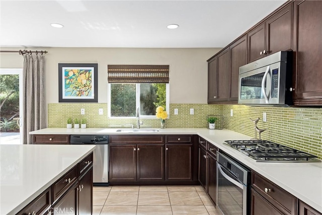 kitchen featuring a healthy amount of sunlight, appliances with stainless steel finishes, light countertops, and a sink