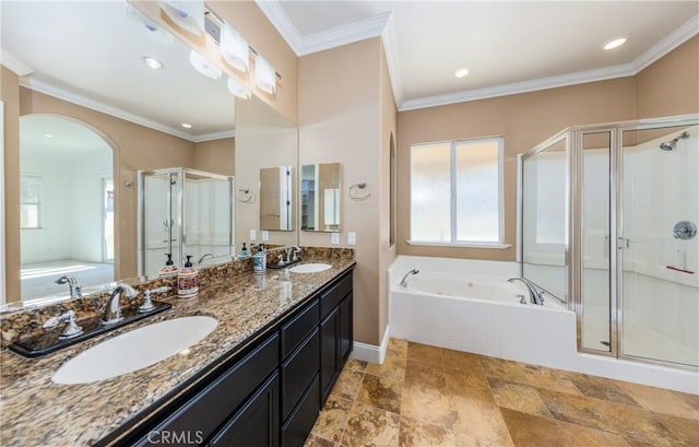 bathroom featuring a bath, a shower stall, crown molding, and a sink