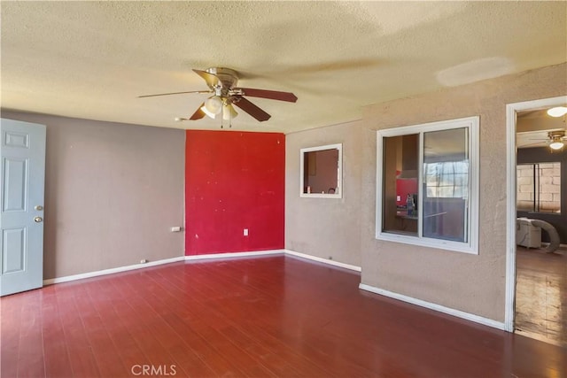 8181 Date St, Fontana, CA 92335 - spare room featuring a textured ceiling, dark wood finished floors, a ceiling fan, and baseboards