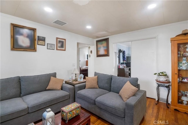 8181 Date St, Fontana, CA 92335 - living room featuring ornamental molding, dark wood-style flooring, visible vents, and recessed lighting