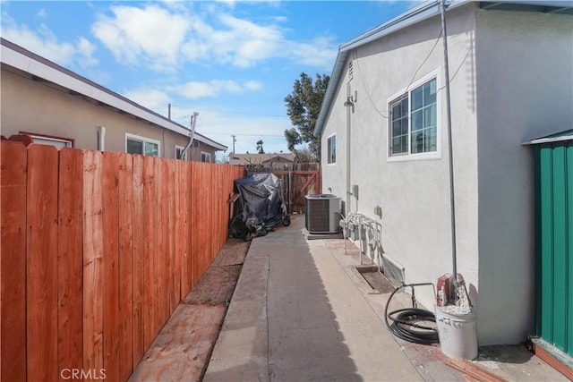 8181 Date St, Fontana, CA 92335 - view of side of property with a patio, fence, cooling unit, and stucco siding