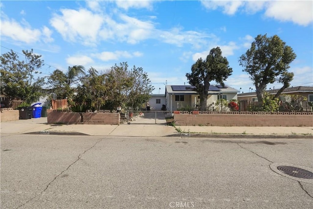8181 Date St, Fontana, CA 92335 - view of front of home with a fenced front yard and roof mounted solar panels