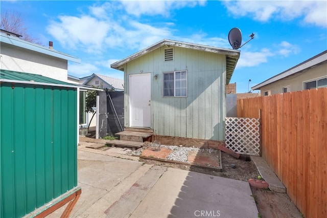 8181 Date St, Fontana, CA 92335 - back of property featuring an outbuilding, a patio, a storage unit, and fence