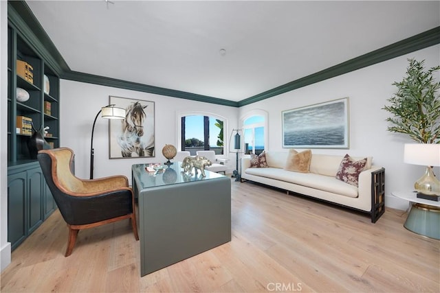 living area with ornamental molding and light wood finished floors