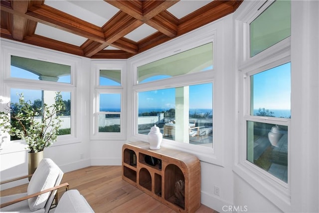 sunroom / solarium featuring a healthy amount of sunlight, coffered ceiling, and beam ceiling