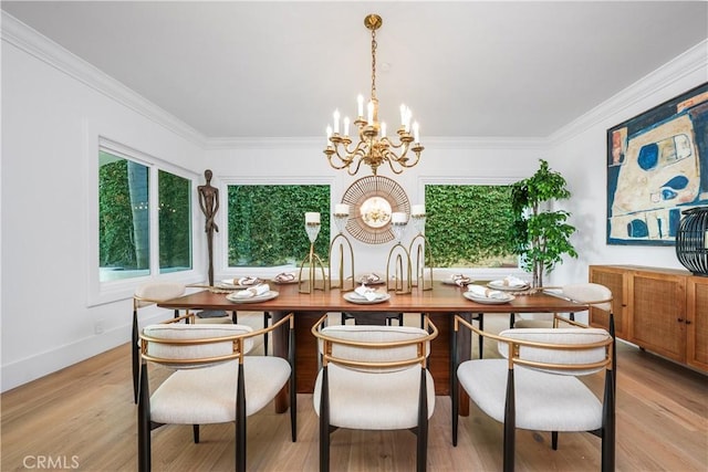 dining room featuring a notable chandelier, light wood finished floors, and crown molding