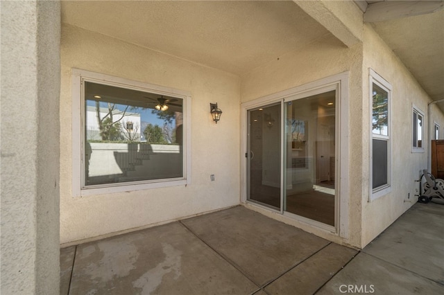 doorway to property with a patio and stucco siding