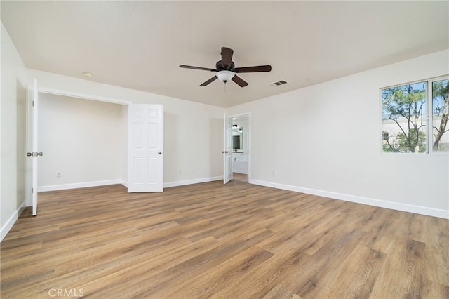 unfurnished bedroom with baseboards, ceiling fan, visible vents, and light wood-style floors