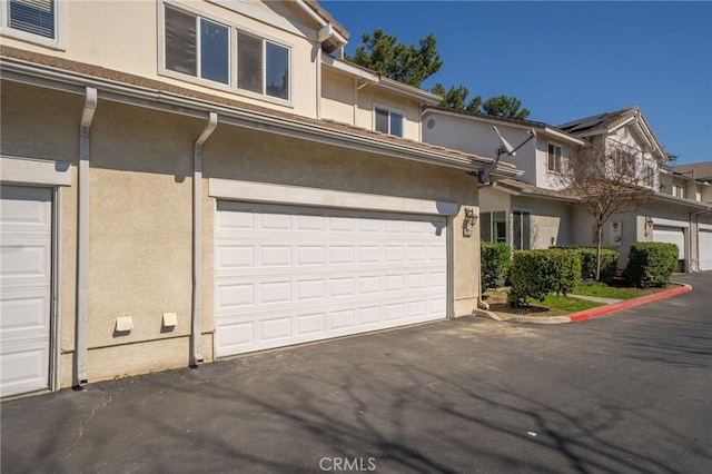 view of front of property with aphalt driveway and stucco siding