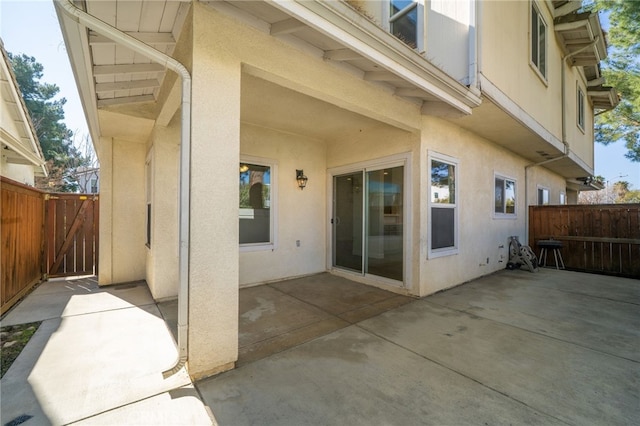 back of property with a patio, a fenced backyard, and stucco siding