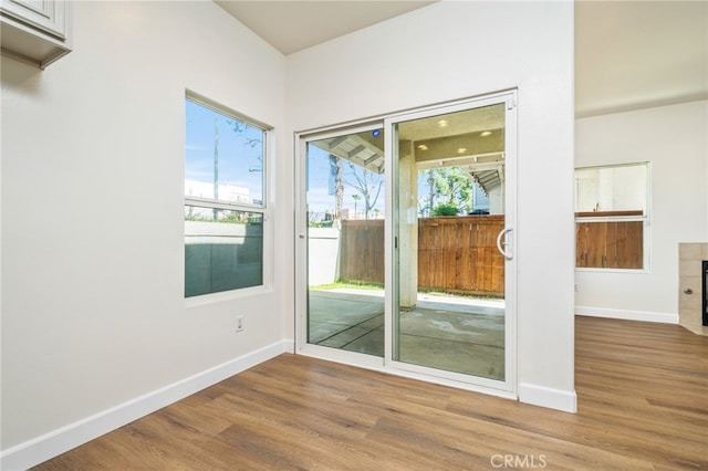 entryway with baseboards and wood finished floors