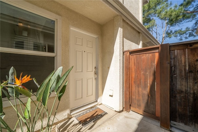 doorway to property featuring stucco siding