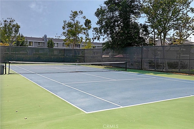 view of sport court featuring fence