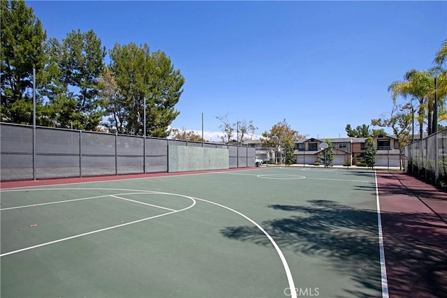 view of basketball court with community basketball court and fence