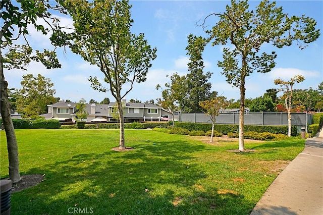 surrounding community with a yard and fence