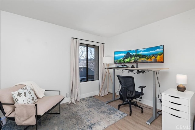 office area featuring light wood-style floors and baseboards