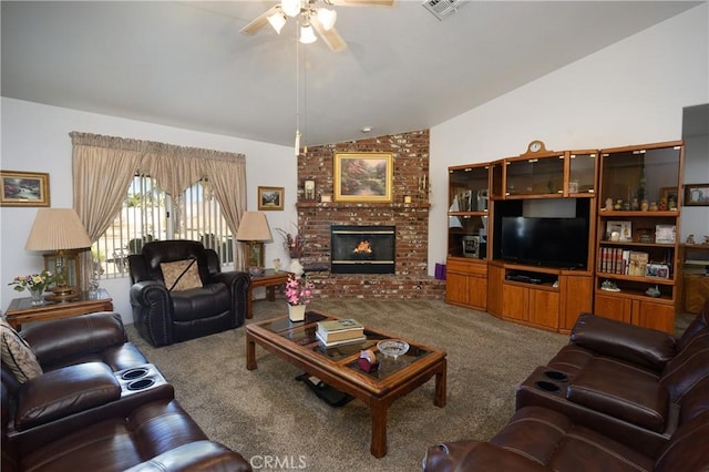 living area featuring carpet, visible vents, a brick fireplace, vaulted ceiling, and ceiling fan