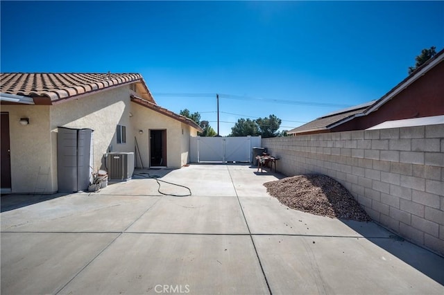 view of patio / terrace featuring a gate, a fenced backyard, and cooling unit