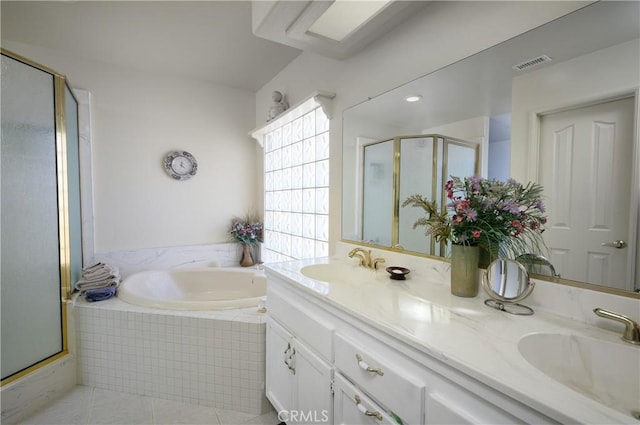 bathroom with a sink, a shower stall, double vanity, and visible vents
