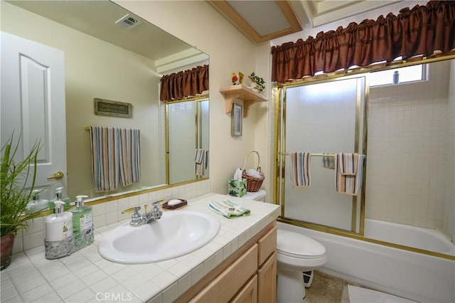 full bathroom with visible vents, shower / bath combination with glass door, toilet, and vanity