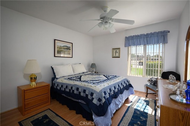 bedroom with a ceiling fan and light wood finished floors