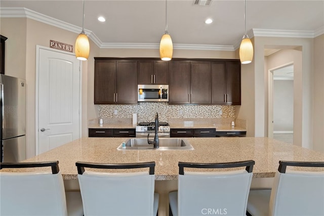 kitchen with appliances with stainless steel finishes, dark brown cabinets, and tasteful backsplash