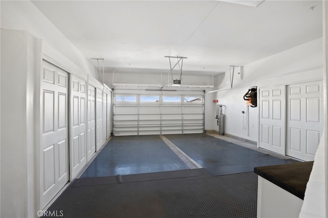 garage with a garage door opener and water heater