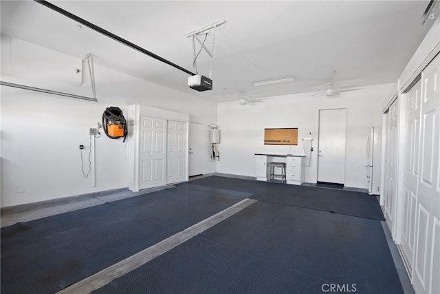 garage with ceiling fan, baseboards, freestanding refrigerator, and a garage door opener