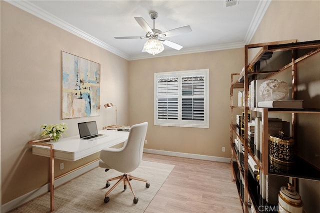 office space featuring a ceiling fan, baseboards, crown molding, and light wood finished floors