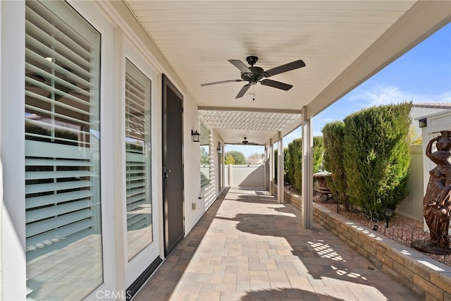 view of patio featuring a gate, ceiling fan, and fence