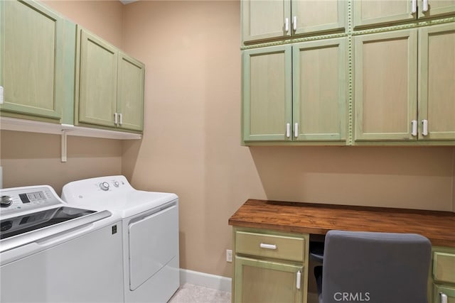 clothes washing area featuring cabinet space, baseboards, and separate washer and dryer