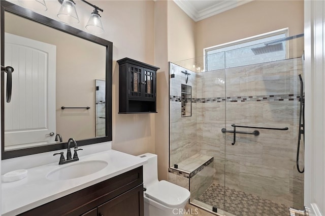 full bath with a stall shower, crown molding, vanity, and toilet